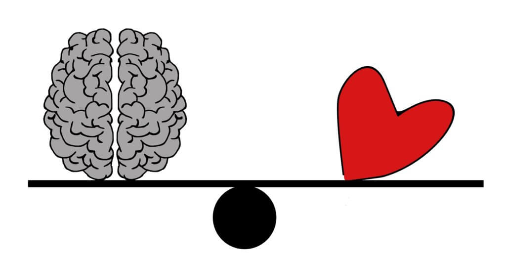 brain and heart balanced on scales