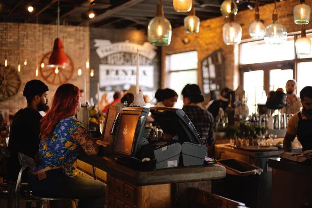 Cafe staff discussing sustainable practices to implement in the workplace