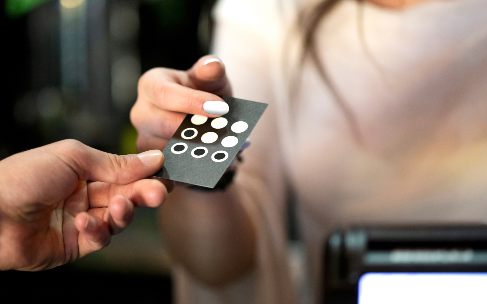 Hand holding a paper punch card. 