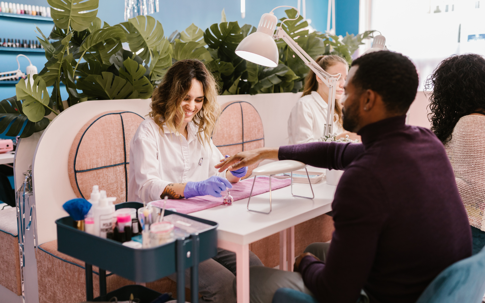 Customer receiving a nail treatment, showcasing a happy and excitable customer base.